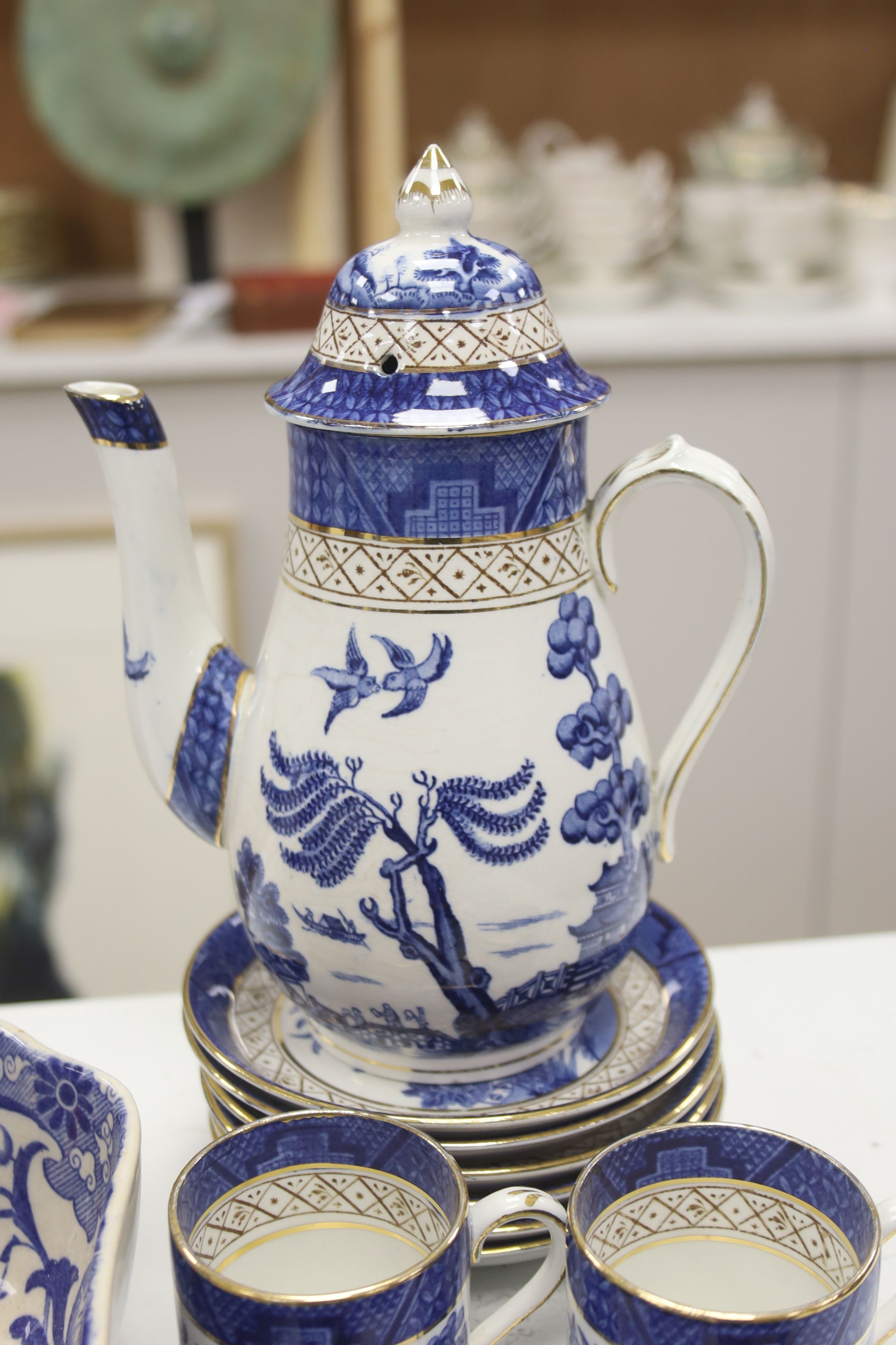 A Wedgwood blue and white willow pattern meat dish, a Copeland Spode Tower pattern square shaped bowl & a blue and white coffee pot (3)